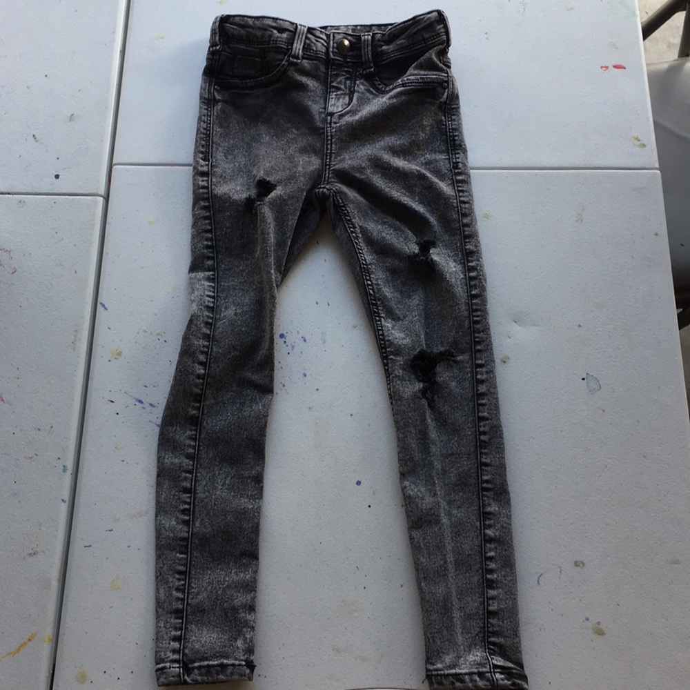 Black/grey ripped jeans.